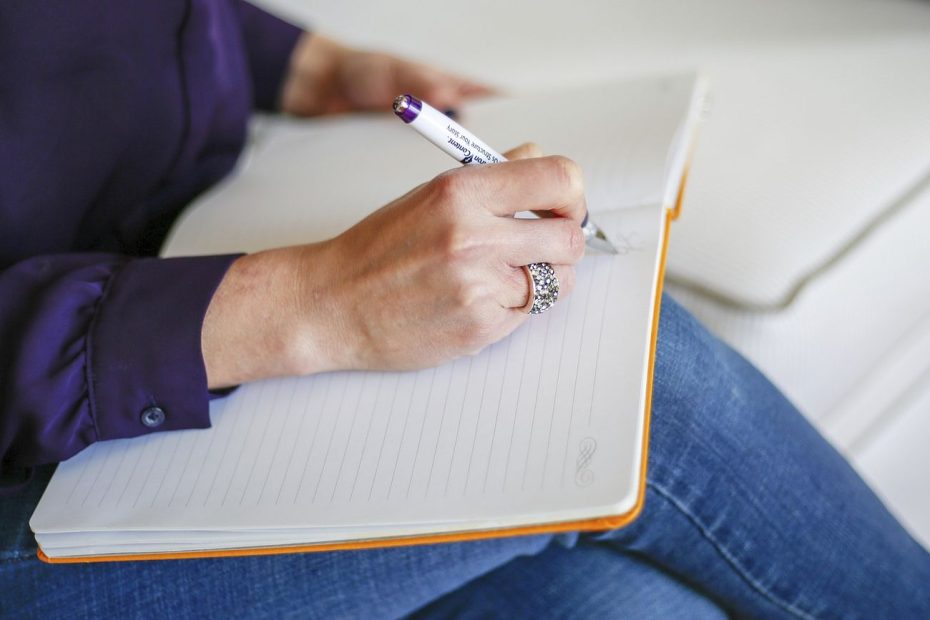 Free woman writing on notebook